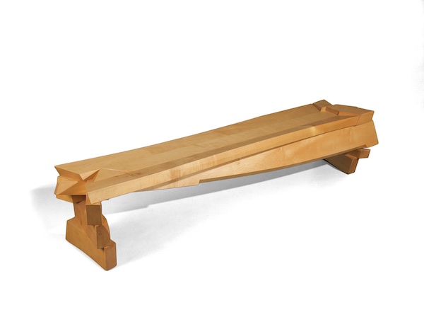 Maple bench woth stacked up legs and dynamic stretcher that connects them and pokes through as a focal point