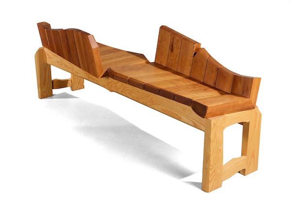 Cherry seat has a sculptural back that takes the classic form of a conversation bench 