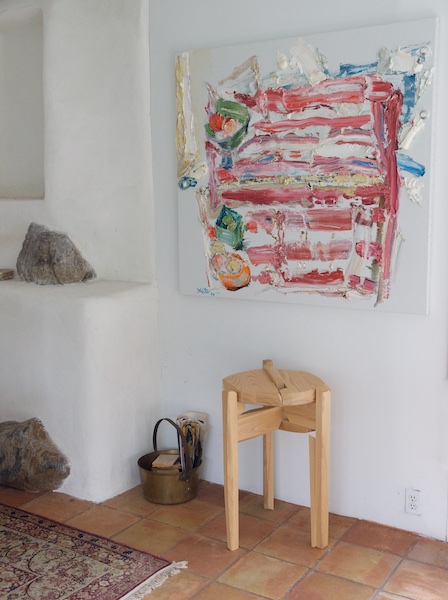 Dynamic small table beneath painting and next to fireplace